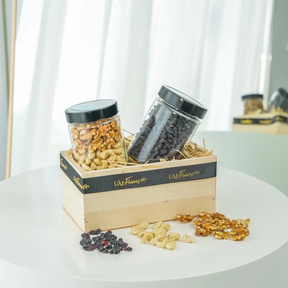 Sets of Mixed cashew & walnuts and black raisins in a wooden tray.