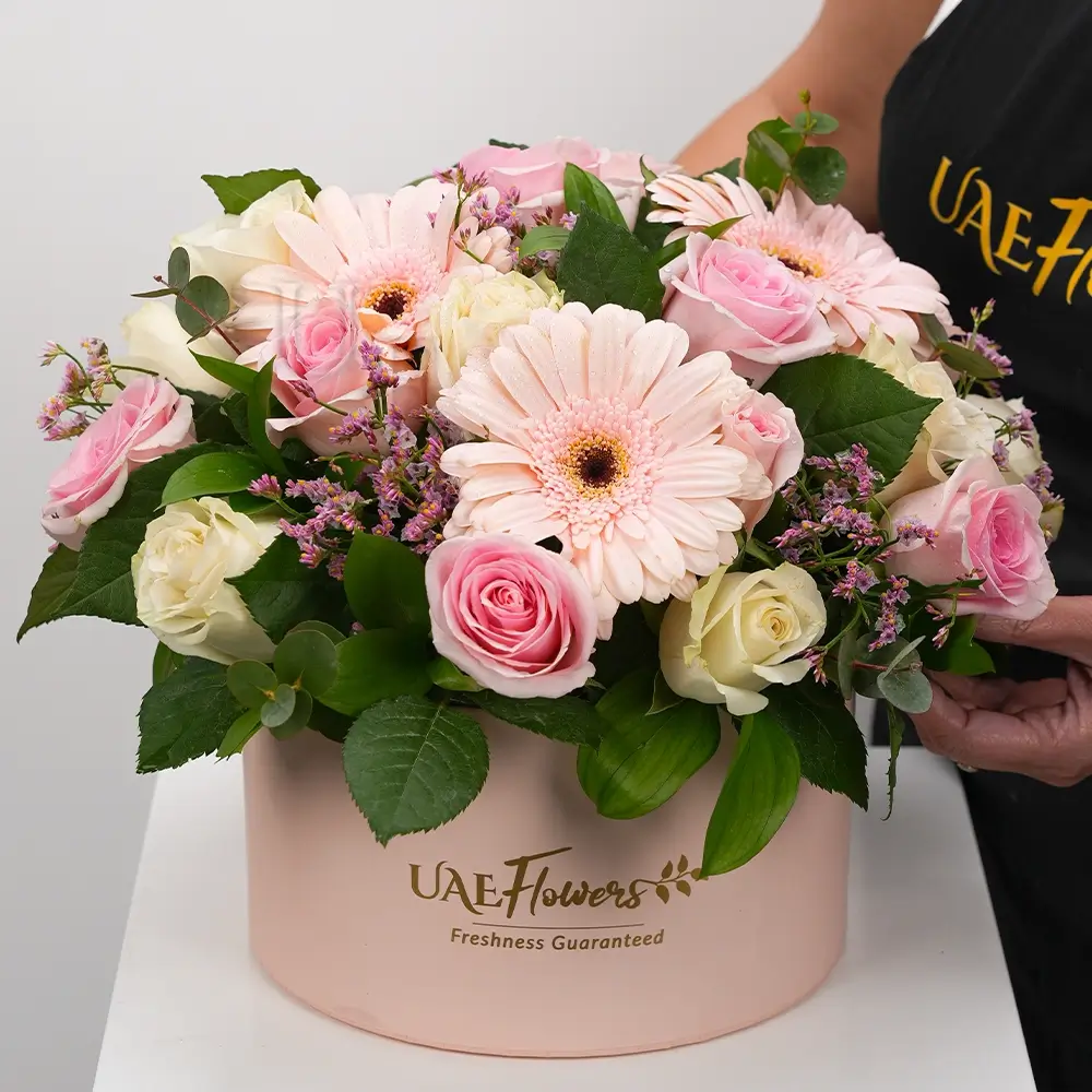 A box arrangement of 3 pink gerberas, 10 pink roses & 10 white roses with greens & fillers