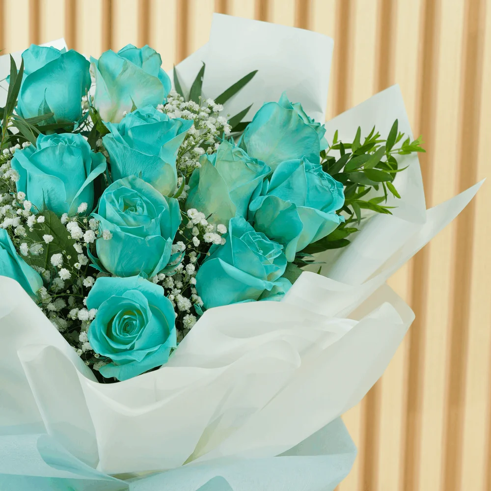 bouquet of 12 vivid blue roses wrapped with care and tied with ribbons