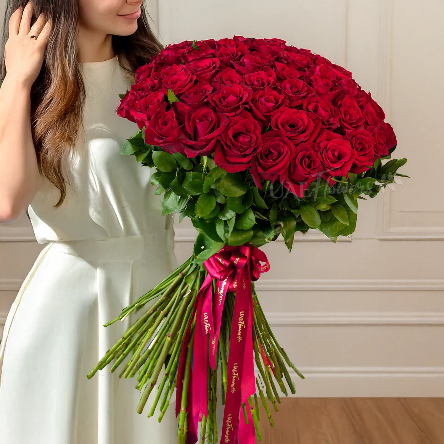 30 red roses hand-tied with red ribbons.