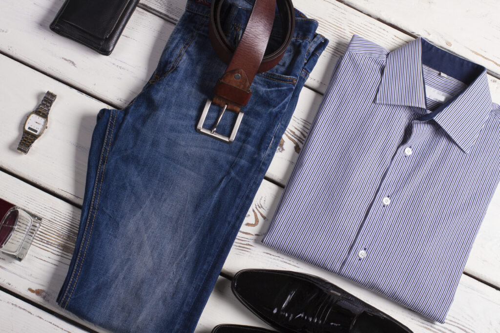 Stylish clothing for Capricorn Man. Men's clothing on a wooden background.