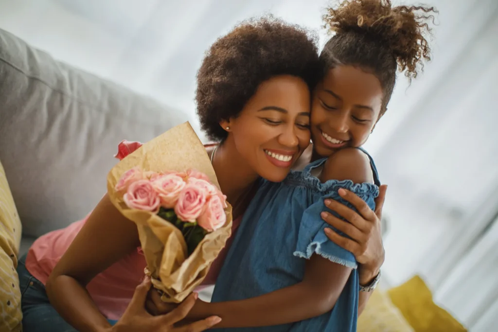 Daughter Hugging Mom with Flower Bouquet 